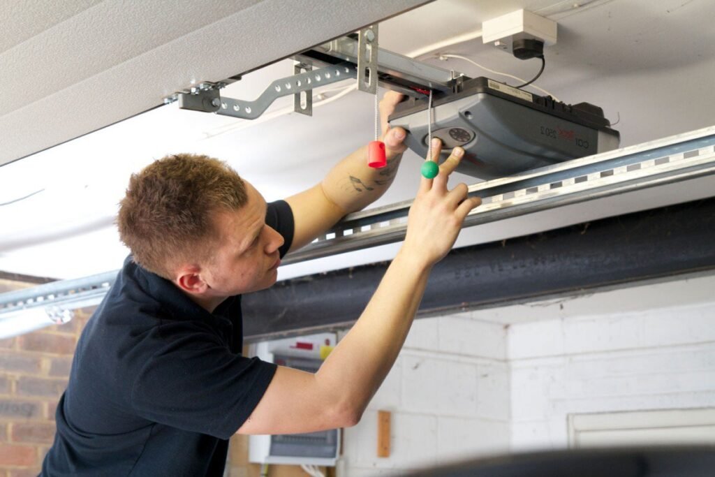 A man is working in Garage door electrical Lock.